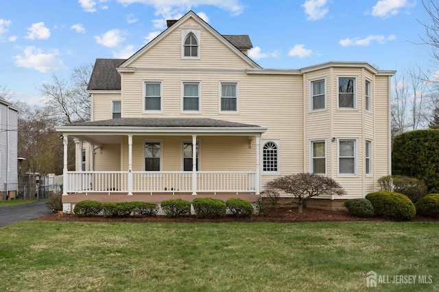 92 Main St, Helmetta, NJ 08828 - view of front of house with covered porch, a front yard, and a shingled roof