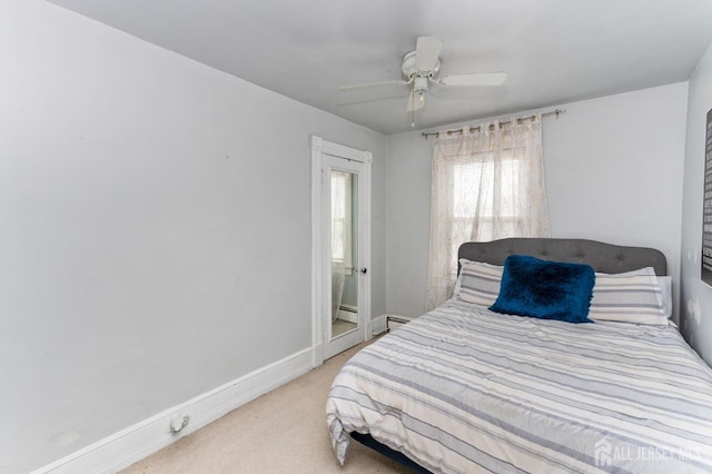 carpeted bedroom with ceiling fan and baseboards