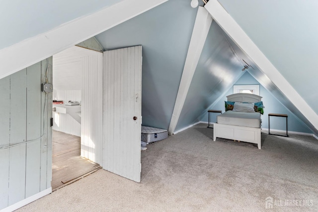 bedroom featuring carpet and vaulted ceiling