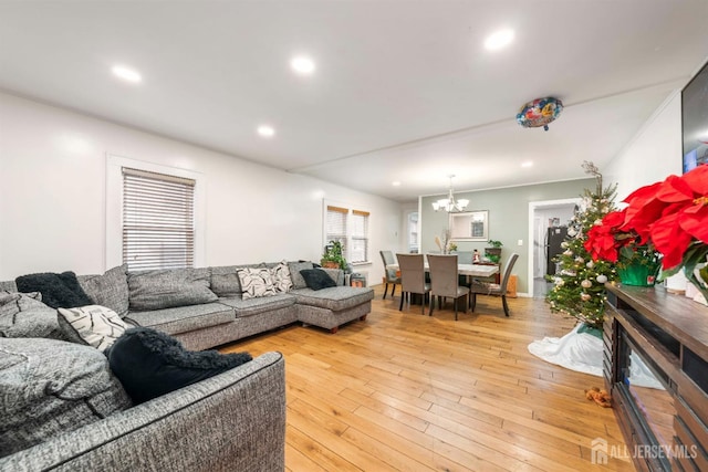 living room with a chandelier and light hardwood / wood-style flooring