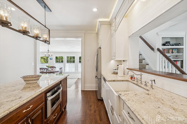 59 S Main St, Cranbury, NJ 08512 - kitchen with a chandelier, appliances with stainless steel finishes, dark wood-type flooring, light stone countertops, and decorative light fixtures