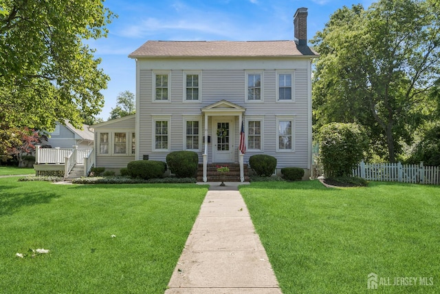 59 S Main St, Cranbury, NJ 08512 - colonial-style house featuring a chimney and a wooden deck