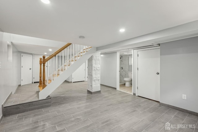 finished basement with stairway, baseboards, recessed lighting, and wood finished floors