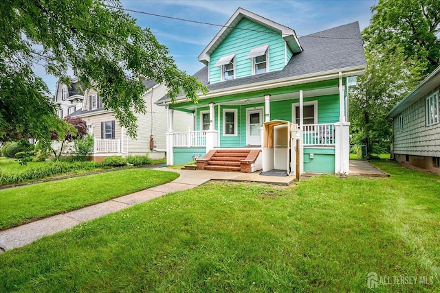 311 Prospect Ave, Dunellen, NJ 08812 - view of front of property featuring a porch, a front lawn, and a shingled roof
