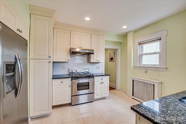 311 Prospect Ave, Dunellen, NJ 08812 - kitchen featuring stainless steel appliances, under cabinet range hood, radiator, dark stone countertops, and light tile patterned flooring