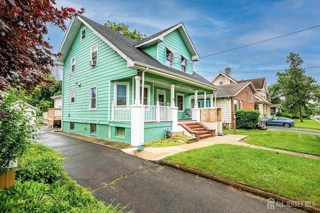 311 Prospect Ave, Dunellen, NJ 08812 - bungalow with a porch, a front yard, and a shingled roof