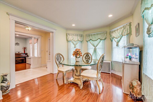 311 Prospect Ave, Dunellen, NJ 08812 - dining space with wood finished floors, ornamental molding, recessed lighting, and radiator heating unit