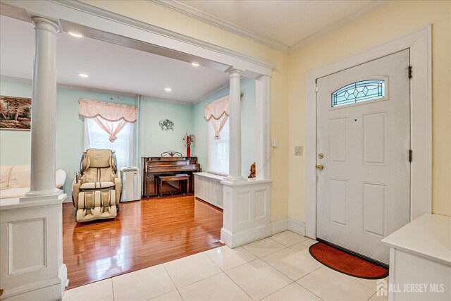 311 Prospect Ave, Dunellen, NJ 08812 - foyer featuring ornate columns, crown molding, light tile patterned floors, and recessed lighting