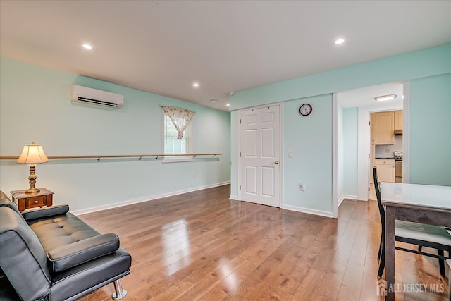 311 Prospect Ave, Dunellen, NJ 08812 - living area with light wood-style flooring, a wall unit AC, and recessed lighting