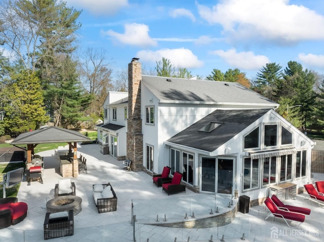 7 Leighton Dr, East Brunswick, NJ 08816 - back of house with roof with shingles, a chimney, a patio area, a sunroom, and an outdoor fire pit