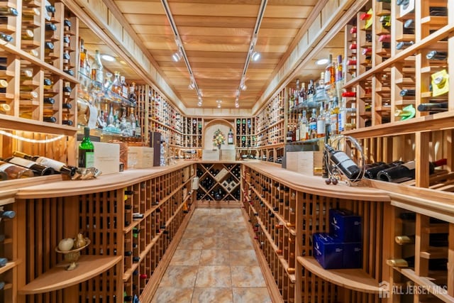 7 Leighton Dr, East Brunswick, NJ 08816 - wine room with wooden ceiling, stone finish flooring, and rail lighting