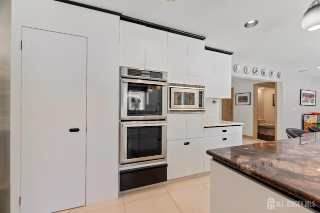 7 Leighton Dr, East Brunswick, NJ 08816 - kitchen with a warming drawer, recessed lighting, white cabinetry, appliances with stainless steel finishes, and light tile patterned floors