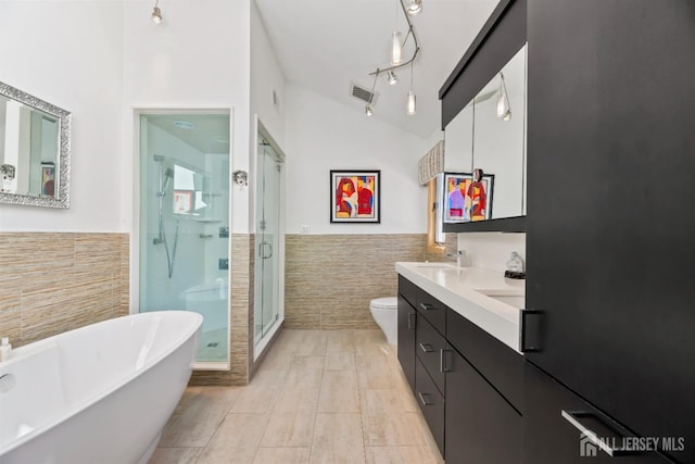 7 Leighton Dr, East Brunswick, NJ 08816 - full bathroom featuring a wainscoted wall, a stall shower, tile walls, toilet, and visible vents