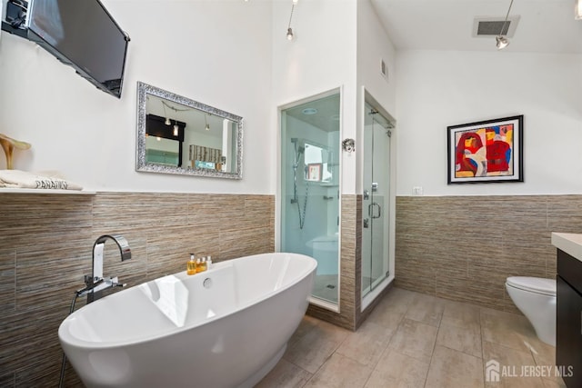 7 Leighton Dr, East Brunswick, NJ 08816 - full bathroom with tile walls, wainscoting, vanity, and visible vents