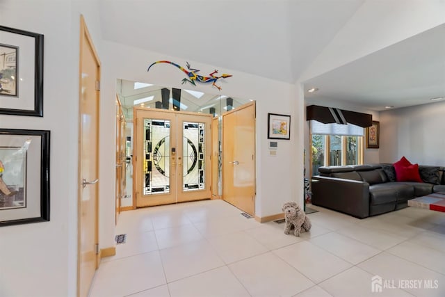 7 Leighton Dr, East Brunswick, NJ 08816 - entryway featuring baseboards, tile patterned floors, french doors, and vaulted ceiling