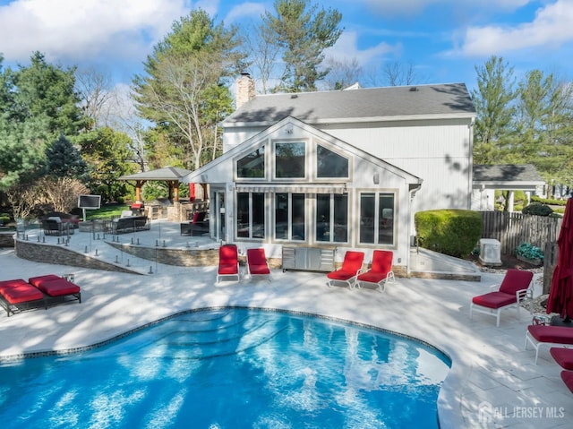 7 Leighton Dr, East Brunswick, NJ 08816 - back of house featuring a storage structure, an outdoor structure, fence, a patio, and a fenced in pool