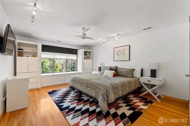 7 Leighton Dr, East Brunswick, NJ 08816 - bedroom with rail lighting, a ceiling fan, visible vents, light wood-type flooring, and baseboards