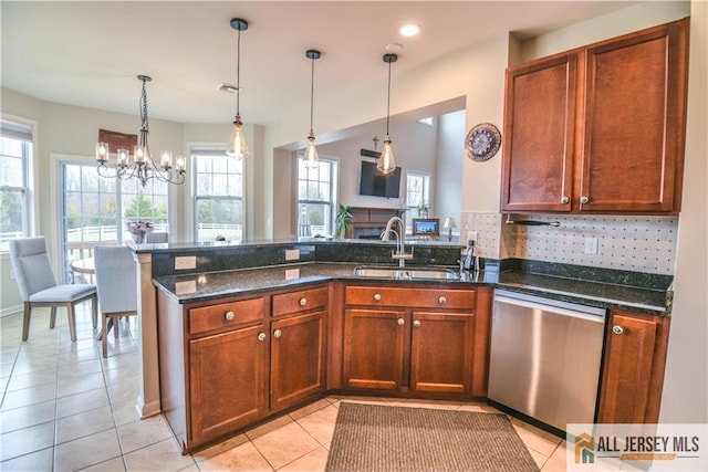 kitchen with dishwasher, a peninsula, a sink, and plenty of natural light