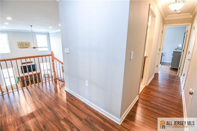 hallway with crown molding, an upstairs landing, wood finished floors, baseboards, and recessed lighting