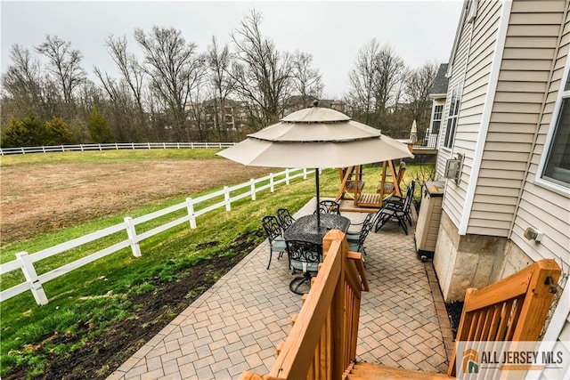 wooden deck with a gazebo, an outdoor living space, a patio area, a fenced backyard, and a yard