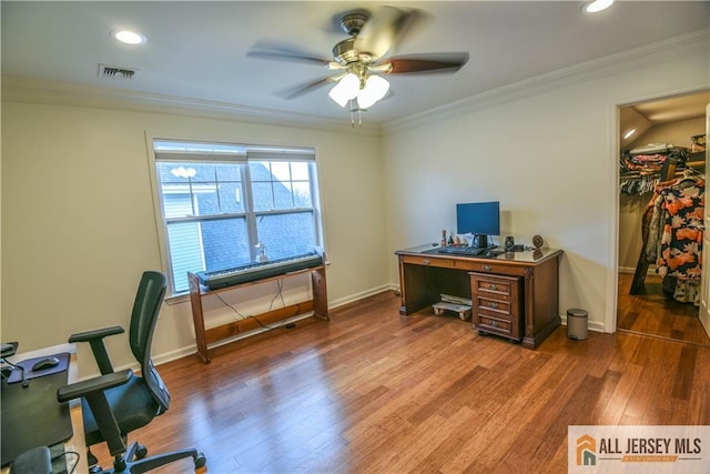 office space featuring wood finished floors, visible vents, baseboards, and ceiling fan
