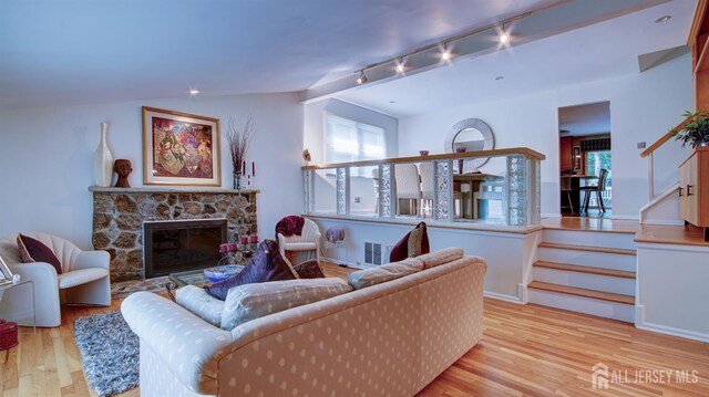 15 Timber Rd, East Brunswick, NJ 08816 - living area featuring wood finished floors, a stone fireplace, and track lighting