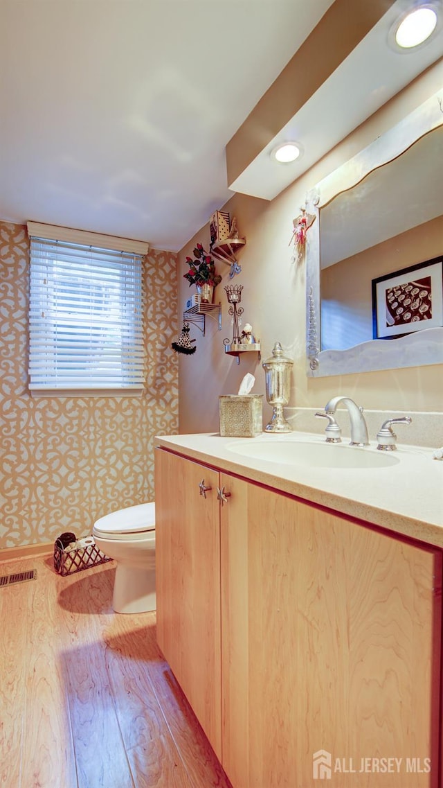 15 Timber Rd, East Brunswick, NJ 08816 - half bathroom featuring vanity, wood finished floors, and wallpapered walls