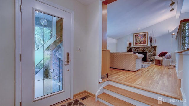 15 Timber Rd, East Brunswick, NJ 08816 - foyer entrance with wood finished floors, a fireplace, and lofted ceiling