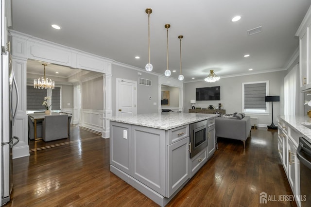 328 Coolidge Dr, Kenilworth, NJ 07033 - kitchen featuring appliances with stainless steel finishes, open floor plan, a chandelier, a kitchen island, and dark wood-type flooring
