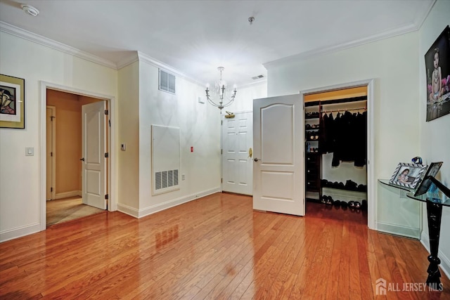 7102 Falston Cir, Old Bridge, NJ 08857 - unfurnished bedroom featuring a chandelier, ornamental molding, wood-type flooring, and a spacious closet