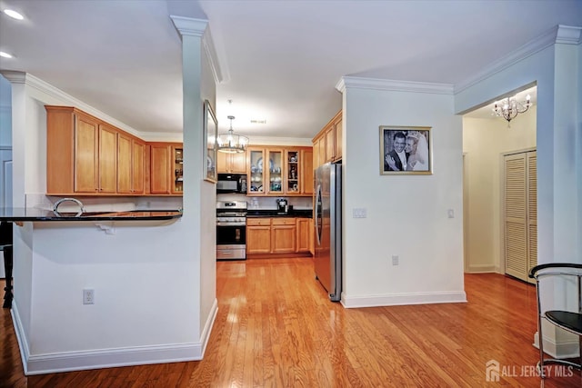 7102 Falston Cir, Old Bridge, NJ 08857 - kitchen with stainless steel appliances, a chandelier, dark countertops, light wood finished floors, and crown molding