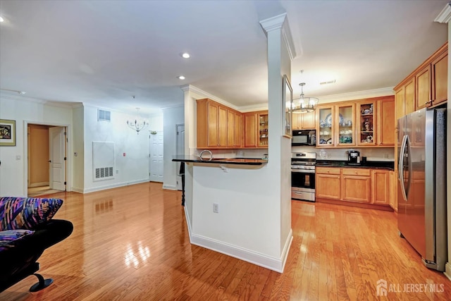 7102 Falston Cir, Old Bridge, NJ 08857 - kitchen with appliances with stainless steel finishes, a chandelier, dark countertops, ornamental molding, and recessed lighting