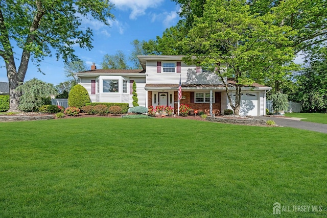 11 Diana Ct, East Brunswick, NJ 08816 - split level home with asphalt driveway, a chimney, a garage, and covered porch