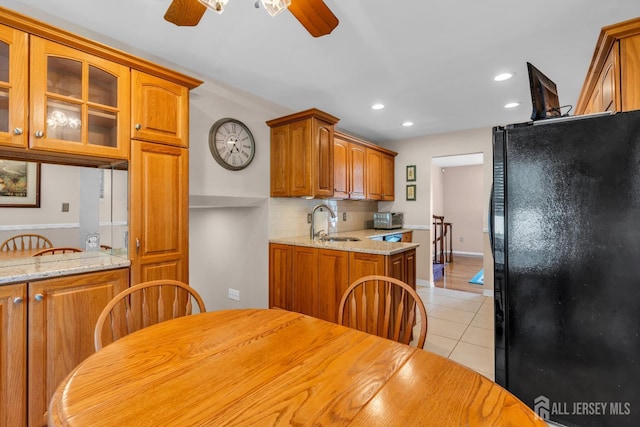 11 Diana Ct, East Brunswick, NJ 08816 - kitchen with freestanding refrigerator, ceiling fan, light tile patterned floors, brown cabinetry, and a sink