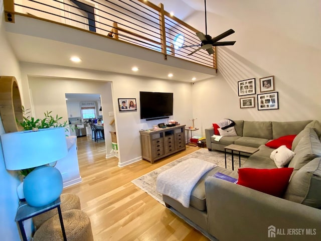 22 E Zoller Rd, East Brunswick, NJ 08816 - living room with wood finished floors, ceiling fan, a towering ceiling, recessed lighting, and baseboards