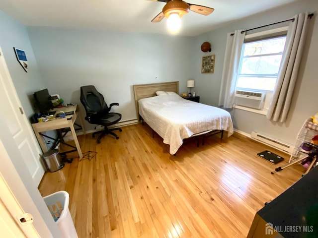 22 E Zoller Rd, East Brunswick, NJ 08816 - bedroom with baseboard heating, light wood-style floors, ceiling fan, and baseboards