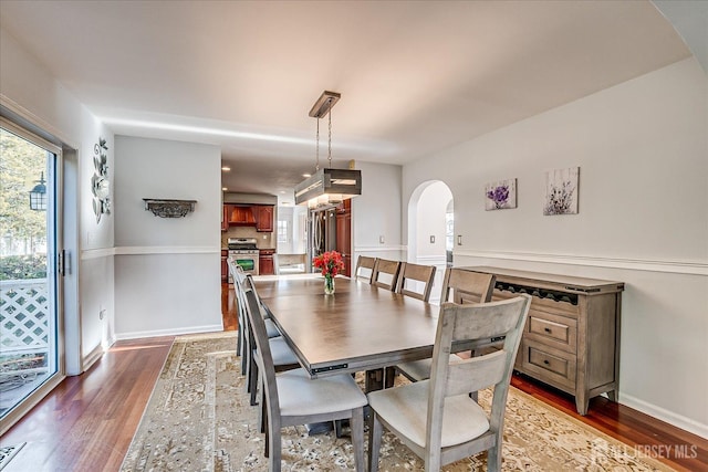 74 Gates Rd, Franklin, NJ 08873 - dining area featuring baseboards, arched walkways, and wood finished floors