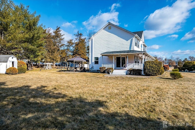 74 Gates Rd, Franklin, NJ 08873 - back of property featuring a lawn, a gazebo, a storage shed, an outbuilding, and a porch
