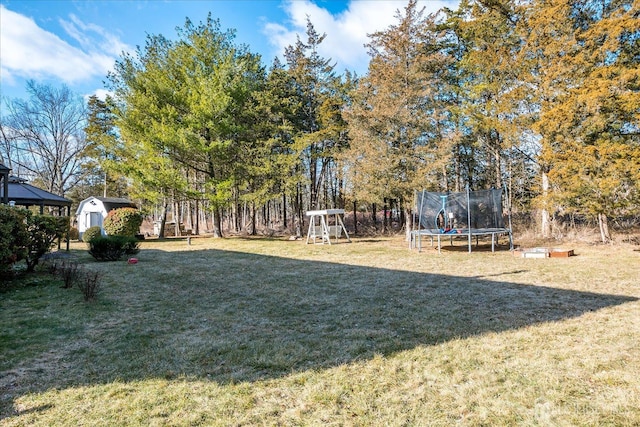 74 Gates Rd, Franklin, NJ 08873 - view of yard featuring an outdoor structure, a playground, a shed, and a trampoline