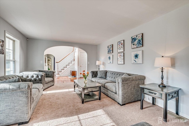 74 Gates Rd, Franklin, NJ 08873 - living room with light colored carpet, arched walkways, and stairway