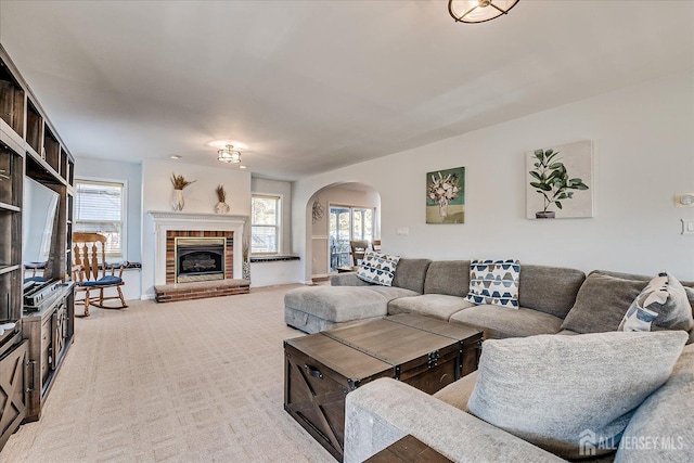 74 Gates Rd, Franklin, NJ 08873 - living room featuring arched walkways, a fireplace, a wealth of natural light, and light carpet