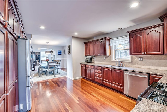 74 Gates Rd, Franklin, NJ 08873 - kitchen featuring appliances with stainless steel finishes, light wood finished floors, tasteful backsplash, hanging light fixtures, and recessed lighting