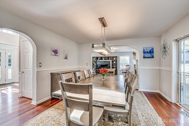 74 Gates Rd, Franklin, NJ 08873 - dining area with visible vents, arched walkways, baseboards, and wood finished floors