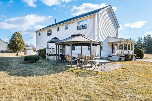 74 Gates Rd, Franklin, NJ 08873 - rear view of property with a storage shed, a gazebo, a lawn, and a patio area
