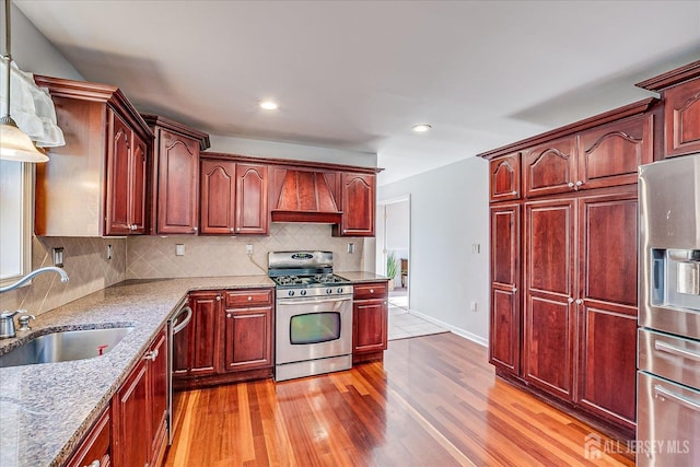 74 Gates Rd, Franklin, NJ 08873 - kitchen featuring stainless steel appliances, a sink, light wood finished floors, and reddish brown cabinets