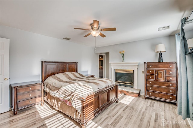 74 Gates Rd, Franklin, NJ 08873 - bedroom featuring light wood-style floors, ceiling fan, and a glass covered fireplace