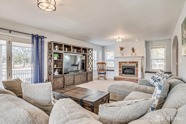 74 Gates Rd, Franklin, NJ 08873 - living room featuring carpet flooring, arched walkways, and a brick fireplace