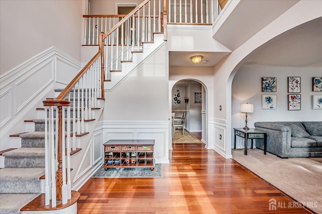 74 Gates Rd, Franklin, NJ 08873 - stairs featuring wood finished floors, arched walkways, wainscoting, and a decorative wall