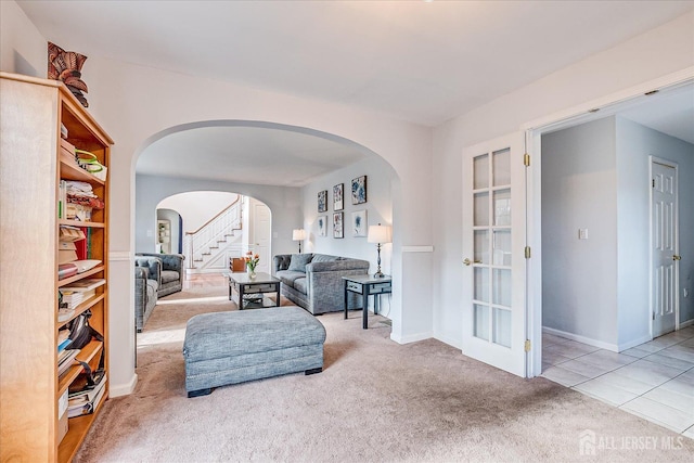 74 Gates Rd, Franklin, NJ 08873 - carpeted living area featuring baseboards, arched walkways, and stairs
