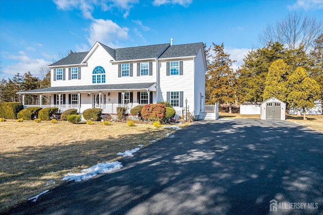 74 Gates Rd, Franklin, NJ 08873 - view of front of house with a porch, an outbuilding, aphalt driveway, and a storage shed